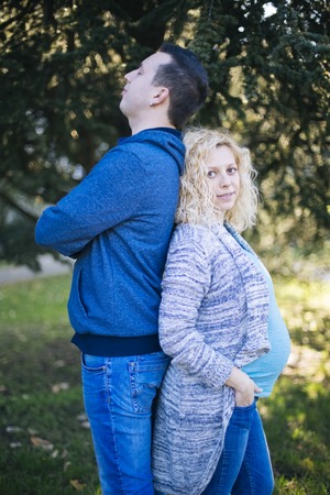 Young pregnant couple in the park