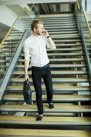 Young businessman on the stairsの写真素材