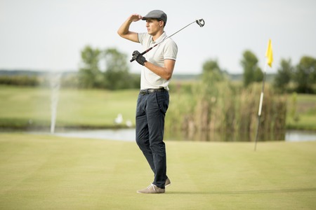 Young man playing golfの写真素材
