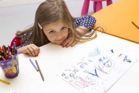 Little girl drawing at playroom