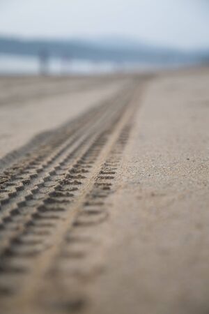 Car trail on sandの写真素材