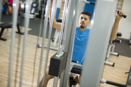 Young man training in the gymの写真素材
