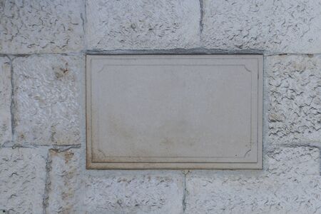 Blank board on the stone wallの写真素材