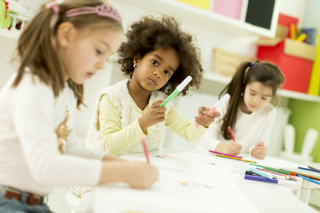 Multiracial children drawing in the playroomの写真素材