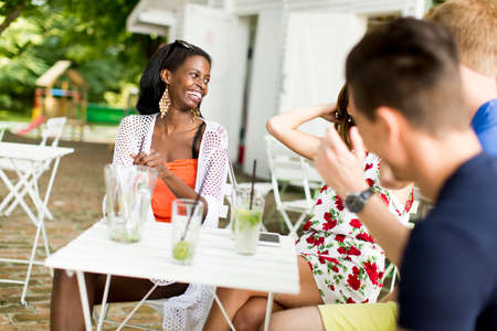 Young multiracial friends at cafeの写真素材