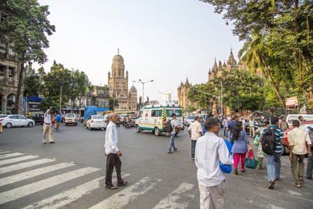 MUMBAI, INDIA - OCTOBER 9, 2015: Unidentified people by the Municipal Corporation Building in Mumbai, India. This gothic building was completed at 1893 and since 2005 is a Grade IIA heritage building.のeditorial素材