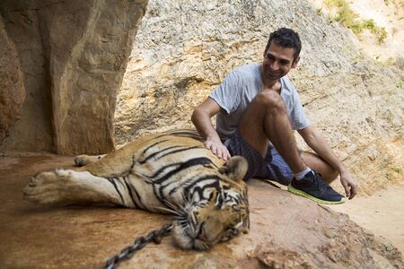 Man in Tiger temple in Thailandの写真素材