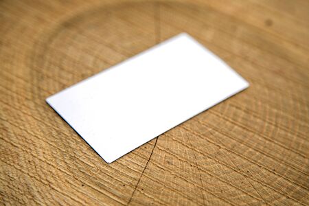 Blank business card on a wooden surfacesの写真素材