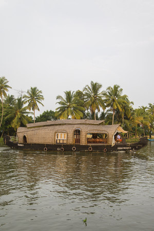 KERALA, INDIA - OCTOBER 16, 2015: Unindetified people at backwaters in Kerala, India. The backwaters are an extensive network of 41 west flowing interlocking rivers, lakes and canals that center around Alleppey, Kumarakom and Punnamada.のeditorial素材