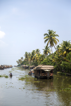 KERALA, INDIA - OCTOBER 16, 2015: Unindetified people at backwaters in Kerala, India. The backwaters are an extensive network of 41 west flowing interlocking rivers, lakes and canals that center around Alleppey, Kumarakom and Punnamada.のeditorial素材