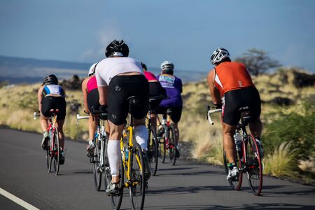 WAIKOLOA, USA - APRIL 3, 2011: Unidentified cyclers on the Lavaman Triathlon in Waikoloa, Hawaii. It is held in Olympics format: 1.5 km swimming, 40 km biking and 10 km running.のeditorial素材