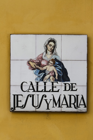 MADRID, SPAIN - MARCH 13, 2016: Closeup of the street sign in Madrid. They are hand-painted ceramic tiles typically composed within 9 or 12 tiles. They depict the name of the alley or street, as well as illustrations that indicate special meanings.のeditorial素材