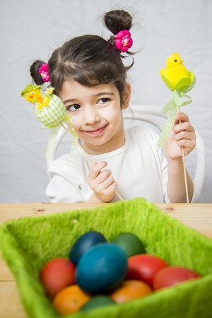 Little girl with a basket full of Easter eggsの写真素材
