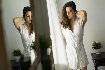 Woman posing in the room by the windowの写真素材