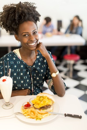 Young african american woman in the dinerの写真素材