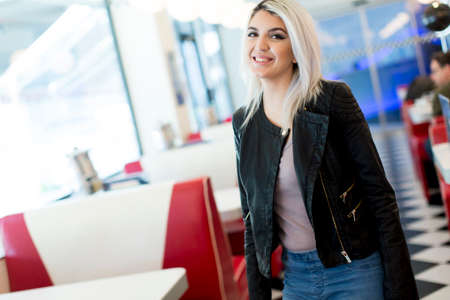 Woman standing and posing in the diner