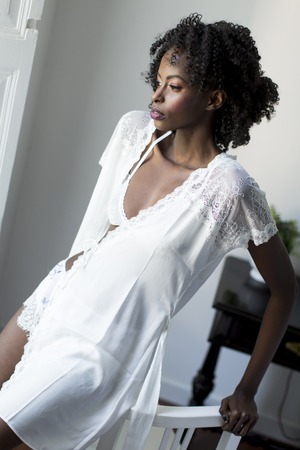 Woman posing in the room by the windowの写真素材