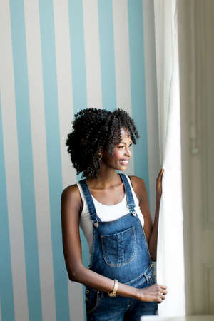 African american woman posing by the wallの写真素材