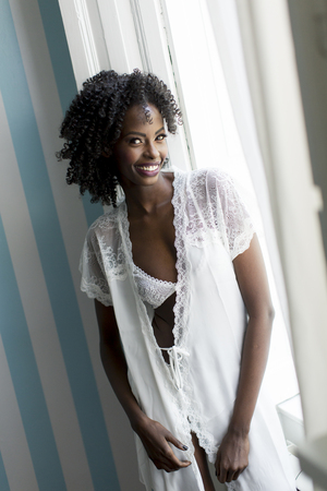 Woman posing in the room by the windowの写真素材