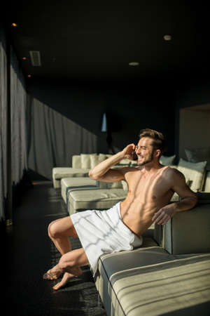 Man with a towel on the phoneの写真素材