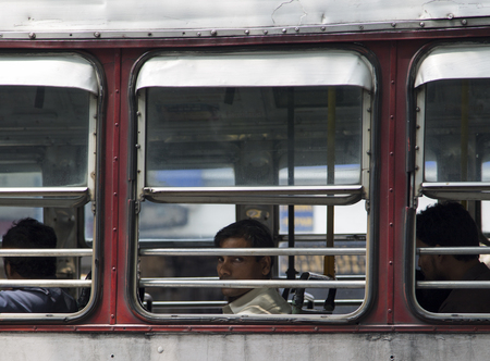 MUMBAI, INDIA - OCTOBER 10, 2015: Unidentified man in the bus. Buses take up over 90% of public transport in Indian cities and serve as a cheap and convenient mode of transport for all classes of society.のeditorial素材