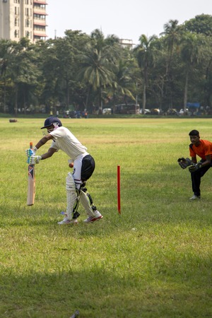 MUMBAI, INDIA - OCTOBER 10, 2015: People playing cricket in the central park at Mumbai, India....