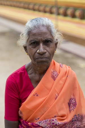 MATALE, SRI LANKA - JANUARY 27, 2014: Unidentified woman in front of hindu temple Sri Muthumariamman Thevasthanam at Matale, Sri Lanka. Temple was established in 1852 by the Indian workers from South India.のeditorial素材