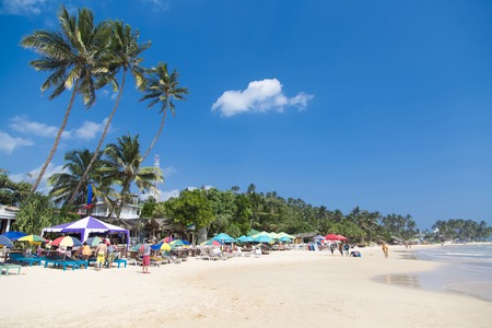 MIRISSA, SRI LANKA - JANUARY 24, 2014: Unidentified tourists at Mirissa beach in Sri Lanka. Mirissa Beach is rapidly becoming a popular surfer hangout during the months of November to March.のeditorial素材