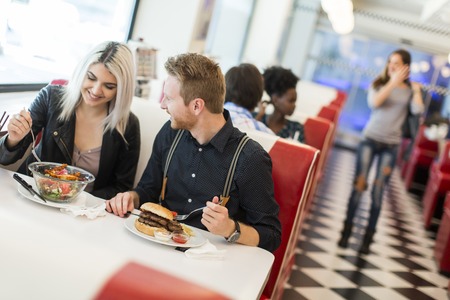 Friends eating at the table in the diner