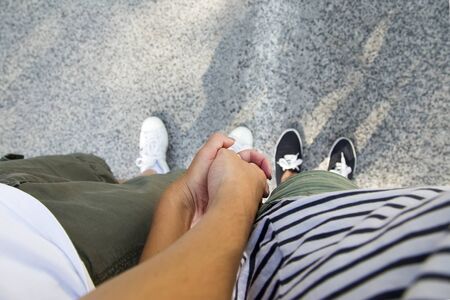 Loving couple holding hands and standing on the edge