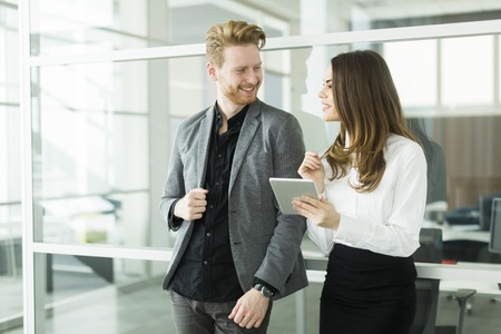 Young business couple using tablet in the officeの写真素材