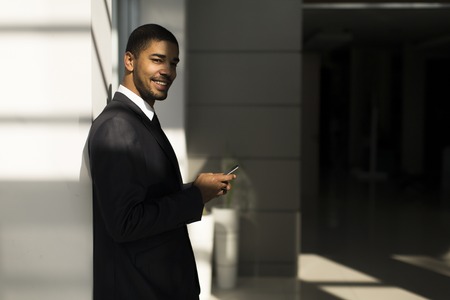 Businessman with a phone in the officeの写真素材