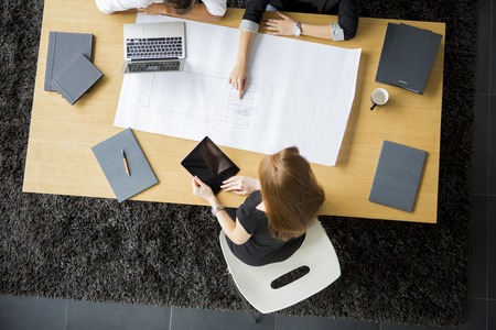 Young architects sitting at the table in the officeの写真素材
