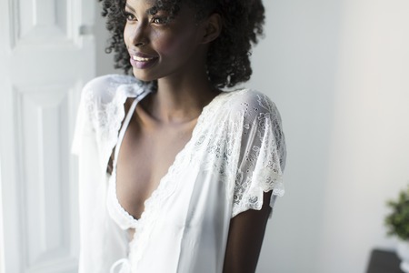 African american woman posing in the room by the windowの写真素材