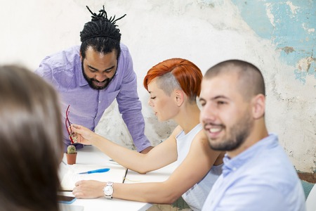 Young people working by the desk in the grunge office