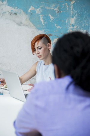 Young people working by the desk in the grunge office