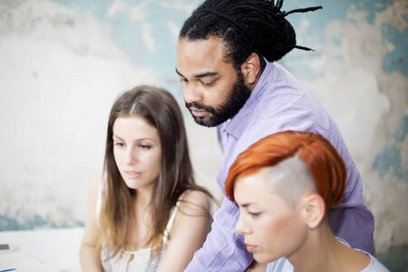 Young people working by the desk in the grunge office
