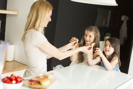 Mother and daughter in the modern kitchen prepating foodの写真素材