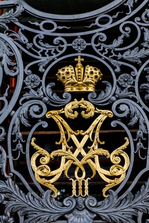 Gate with monogram of Emperor Alexander III and Empress Maria Fyodorovna at Hermitage in Saint Petersburg, Russia.の写真素材
