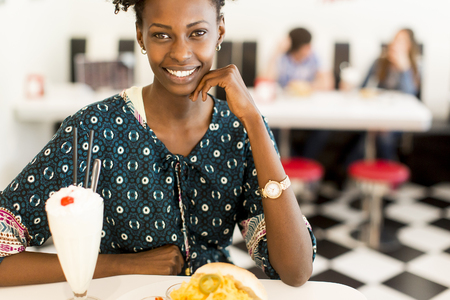 Young african american woman in the dinerの写真素材