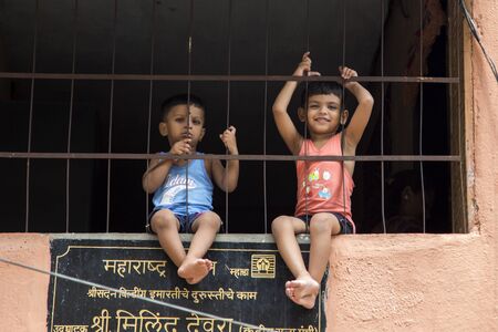 MUMBAI, INDIA - OCTOBER 9, 2015: Unidentified children on the street of Mumbai, India. With 12 million people, Mumbai is the most populous city in India and the 9th most populous agglomeration in the world.のeditorial素材