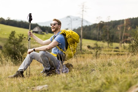 Young backpacking man rest at the hillの写真素材