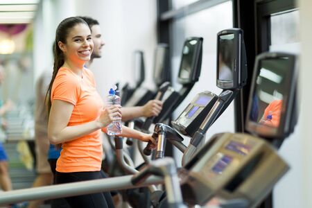 Young people training on a cross trainer