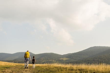 Young father and daughter enjoy hiking on a sunny dayの写真素材