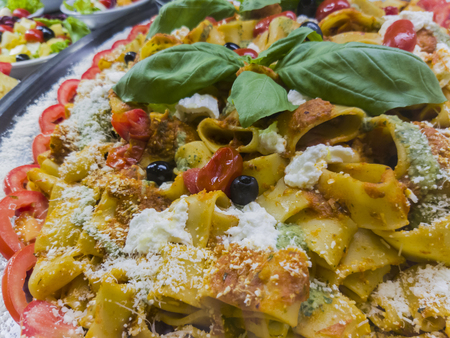 Close up view at Italian pasta meal with basil on topの写真素材