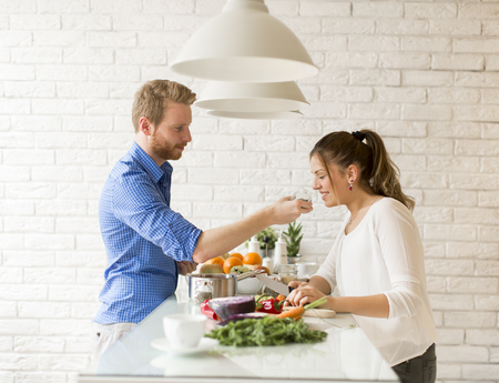 Couple cooking together in the modern kitchen at homeの写真素材