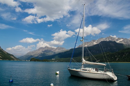 Yacht at Lake Silvaplana in Switzerland at August 5, 2013. Lake have a predictable winds and is popular venue for windsurfing and kitesurfingのeditorial素材