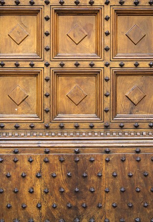 Closeup view at old wooden door from Siena, Italy