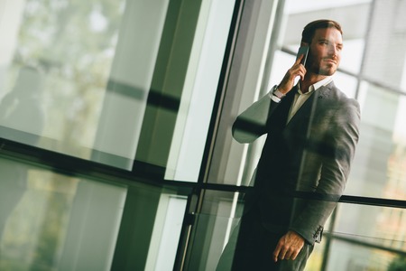Modern businessman talking over the phone in the office