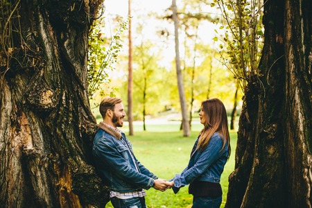 Loving young couple in the autumn parkの写真素材